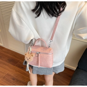 Pink PU leather crossbody bucket bag with cute bear charm and silver hardware detail