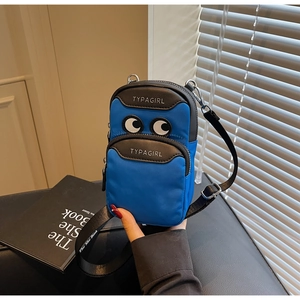 Detail of blue nylon phone bag with cartoon eyes decoration and adjustable strap