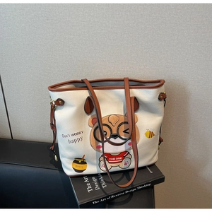 Detail of bear print and honey jar design on cream faux leather tote bag