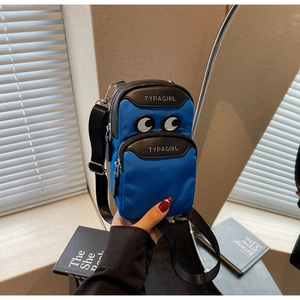 Detail of a blue nylon phone bag with large cartoon eyes and double zipper pockets
