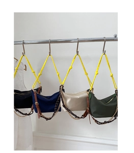 Detailed view of four colorful nylon hobo bags with yellow braided ropes and metal chains