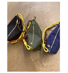 Three colors of nylon crescent crossbody bags featuring distinctive rope and chain straps