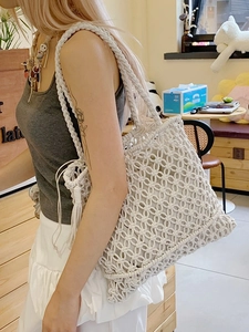 Large cream hand-woven straw tote bag with diamond cutout patterns for summer vacation