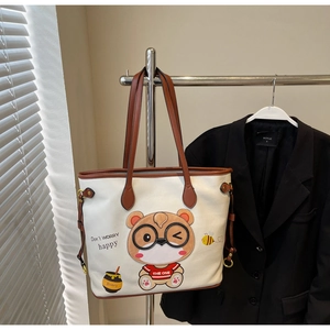 Detail of cute bear tote bag with premium pebbled leather texture and metal buckle