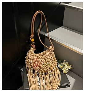 Close-up of handmade woven tassel bucket bag with intricate mesh and wood bead details