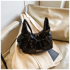 Detail of black pleated leather hobo bag with MKMX metal logo and side pocket