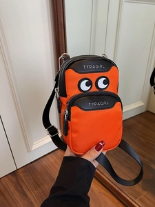 Minimalist canvas shoulder bag with cartoon eye design and orange black color splicing