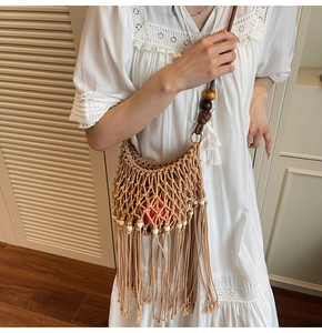 Close-up of woven hollow bag featuring vibrant multi-colored wood beads and long fringe