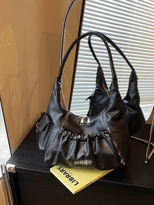 Black vintage pleated underarm bag with silver zippers and soft leather texture