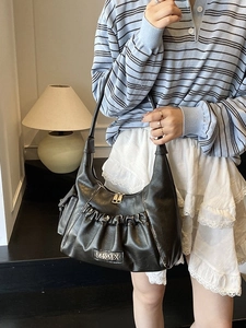 Retro black leather shoulder bag with ruched design and metallic MKMX logo detail