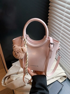 Pink glossy bucket bag with round handles and cute bear charm, elegant handheld tote bag