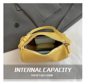 Interior view of yellow pebble leather cylinder bag showing capacity for small items