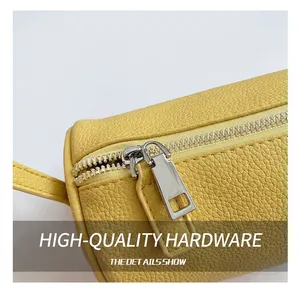 Close-up of yellow lychee grain leather with high-quality silver metal zipper detail