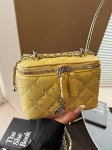 Yellow quilted mini box bag with crystal studs and camellia charm chain strap