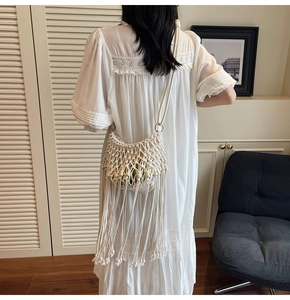 Detailed view of handmade white woven mesh shoulder bag with long tassel fringe bohemian style