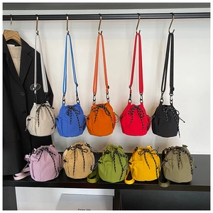 Detail view of colorful nylon drawstring bucket bags with adjustable shoulder straps