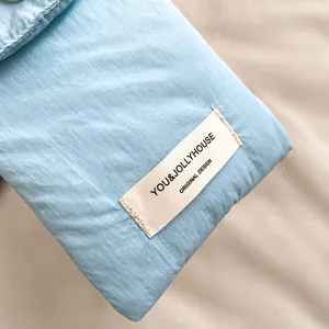 Close-up of light blue fabric texture with original design label and neat stitching