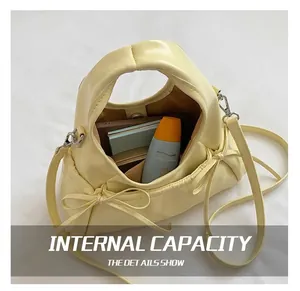 Top view of pale yellow handbag interior showing storage capacity for cosmetics