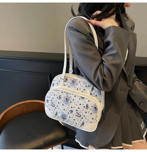 Close-up of quilted cream tote bag with blue cartoon bear and rocking horse patterns