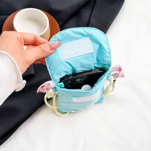 Detail showing internal capacity of the mini nylon crossbody phone bag for smartphones