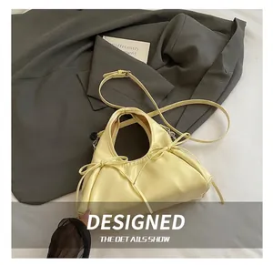 Detail showing pale yellow bow accents and soft texture on the large tote shoulder bag