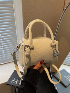Elegant cream lychee leather pillow bag with silver hardware and adjustable strap
