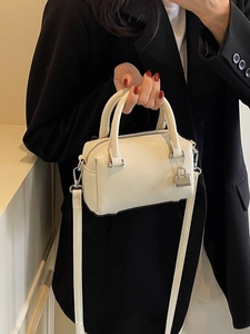 Chic off-white lychee grain boston handbag with dual handles and crossbody strap