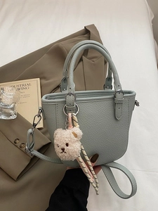 Chic light blue lychee pattern bucket bag with teddy bear charm and striped cord