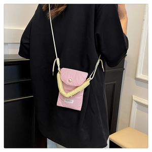 Detailed back view of pink pleated crossbody phone bag with pearl button and carry strap