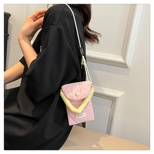 Detail of pink fabric phone bag with large pearl buckle and Stay Positive label