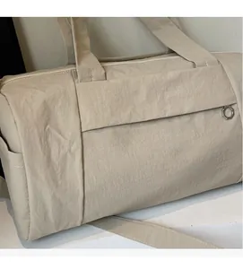 Detail view of beige yoga travel bag featuring soft waterproof fabric and durable straps