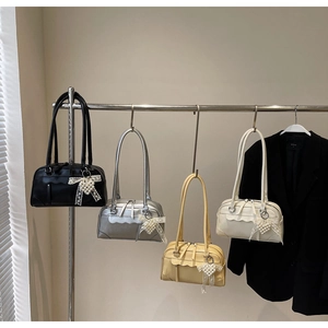 Détail de sacs Boston colorés avec des breloques noeud en perles et de longues anses