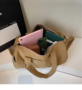Interior view of large khaki travel bag showing storage space for tablet and wallet