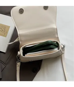 Internal view of beige PU crossbody bag showing the zipper pocket and ample storage space