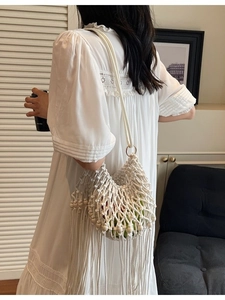 Bohemian hollow woven shoulder bag with tassels and wooden beads for summer vacations