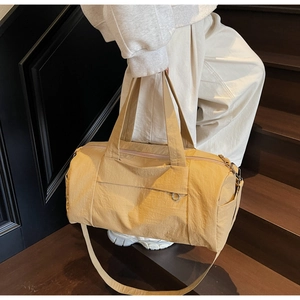 Close-up of lightweight nylon travel bag with dual handles and metal ring accents