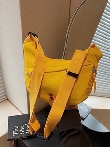 Bright yellow nylon crescent dumpling crossbody bag with wide strap for casual wear