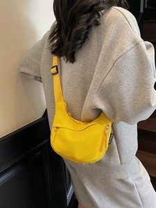 Bright yellow nylon crescent crossbody bag with multi-zipper and adjustable strap
