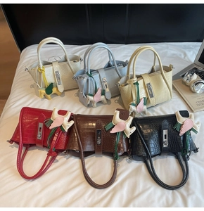 Detailed view of crocodile texture handbags in six colors with stylish pegasus charms