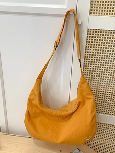 Chic mustard yellow hobo crossbody bag with white heart embroidery and adjustable strap