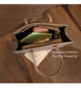 Detailed view showing the spacious interior and compartments of this tan tote bag