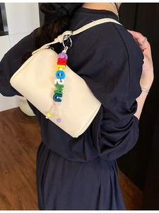 Cream lychee leather cylinder shoulder bag for women with colorful beaded charm