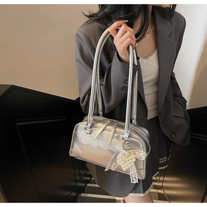Detail of silver metallic Boston bag with wave stitching and pearl bow pendant