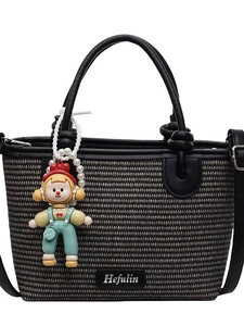 Woven straw bucket bag with cute doll charm and adjustable shoulder strap in black-grey