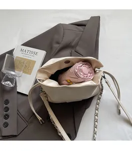 Interior view of off-white leather bucket bag showing large capacity for a folding umbrella