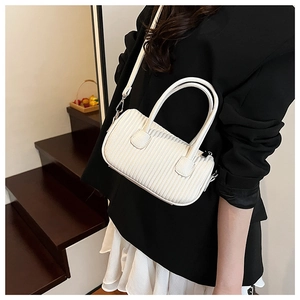 Detailed view of white pleated pillow bag with dual handles and adjustable shoulder strap