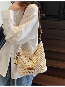 Beige crochet shoulder bag with mesh texture and brown strap for summer beach vacation