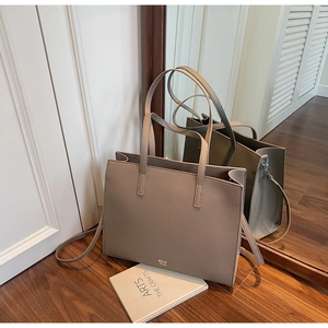 Detail view of the khaki large tote bag featuring high-quality lychee grain leather texture