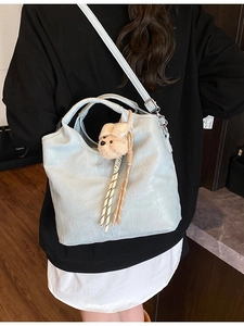 Light blue faux crocodile bucket bag with cute plush bear charm and detachable strap