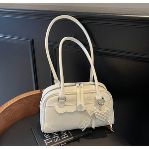 Detailed macro view of cream PU leather texture with pearl heart and lace bow charms